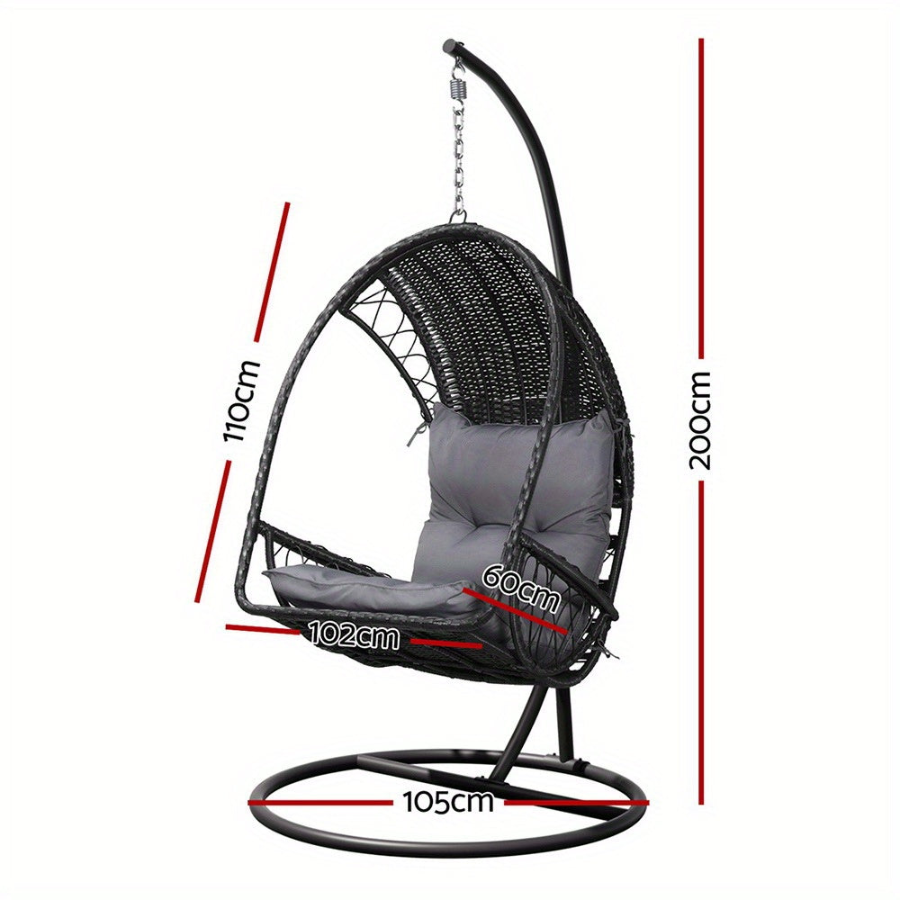 Nutshell outdoor egg chair hammock with woven rattan and gray cushions and black metal stand for patio relaxation
