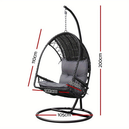 Nutshell outdoor egg chair hammock with woven rattan and gray cushions and black metal stand for patio relaxation