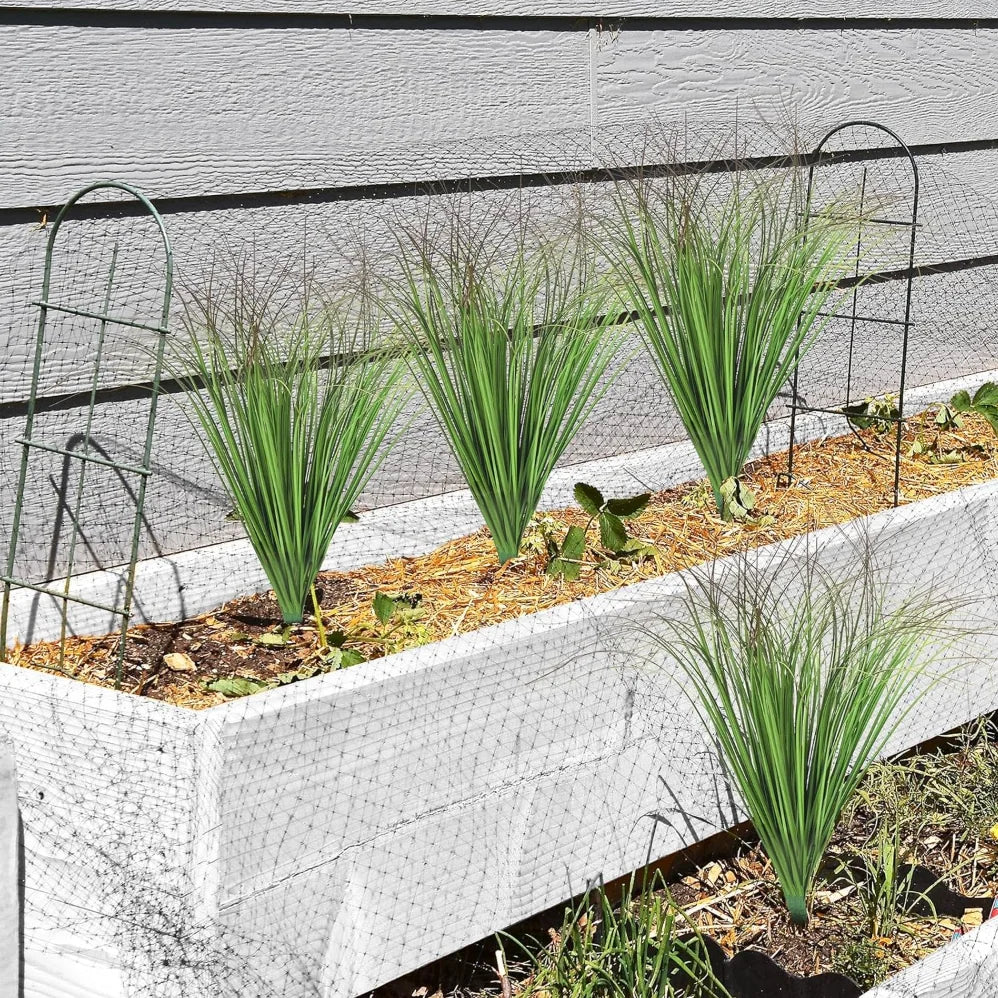Nutshell Faux onion grass artificial plant in white raised planter box for low maintenance patio decor