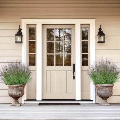 Nutshell faux plants displayed as Faux onion grass artificial plant in matching stone urns flanking a beige entry door