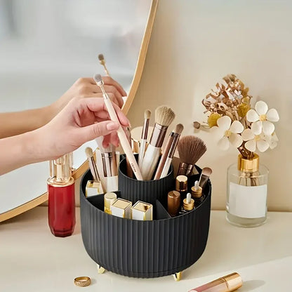 Nutshell 360 degree rotating makeup organizer in black holding makeup brushes and lipsticks on bathroom counter