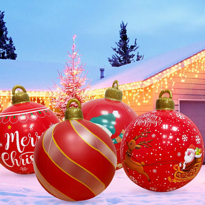 Giant outdoor Christmas inflatable ball set featuring festive designs in a snowy setting