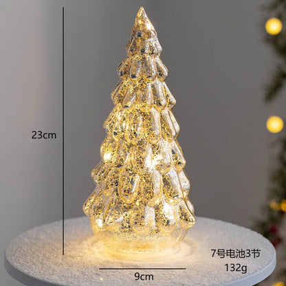 Decorative glass Christmas tree ornament glowing with warm lights, 23 cm tall and 9 cm wide