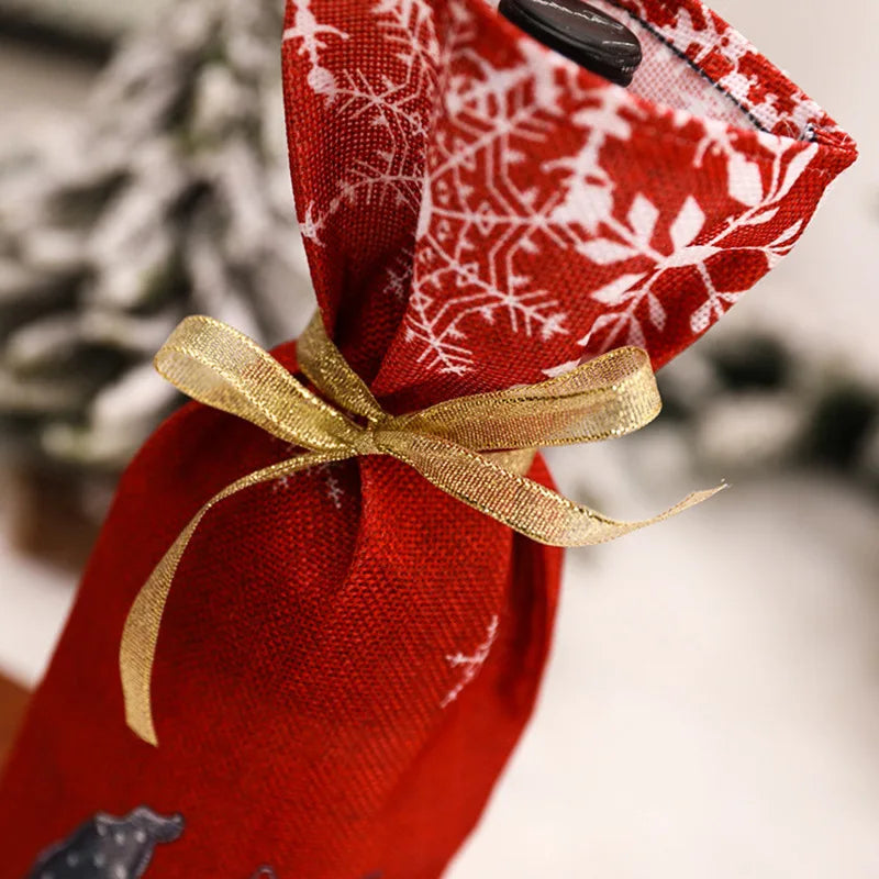 Gnome Christmas wine bottle cover in red fabric with floral design and gold ribbon for festive gifting