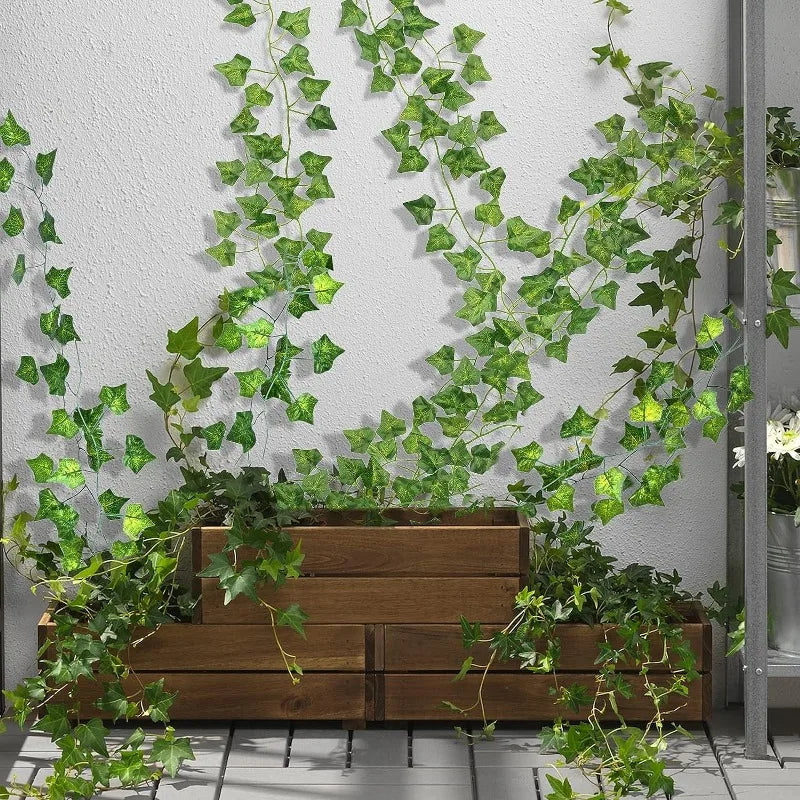 Nutshell Artificial Green Ivy Leaf Rattan Creeper Vine trailing from wooden planters against a white wall