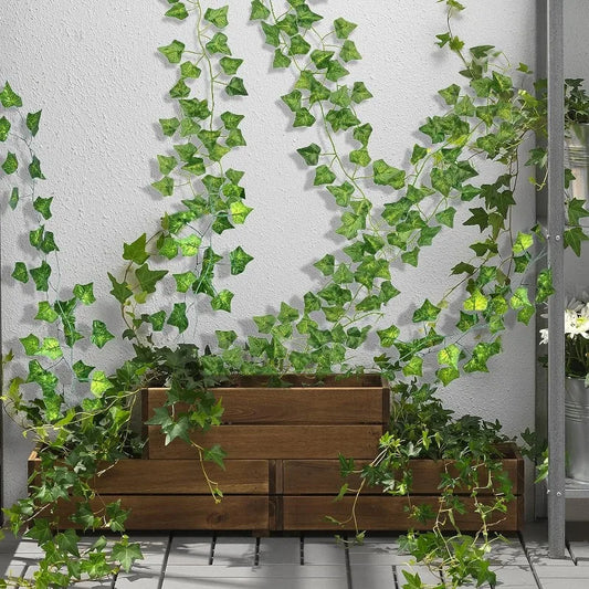 Nutshell Artificial Green Ivy Leaf Rattan Creeper Vine trailing from wooden planters against a white wall