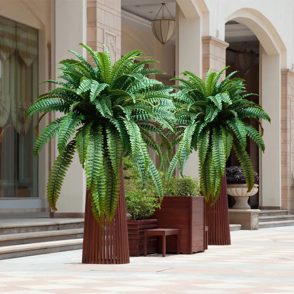 Nutshell artificial fern hanging plant duo in tall brown planters on hotel courtyard with arches