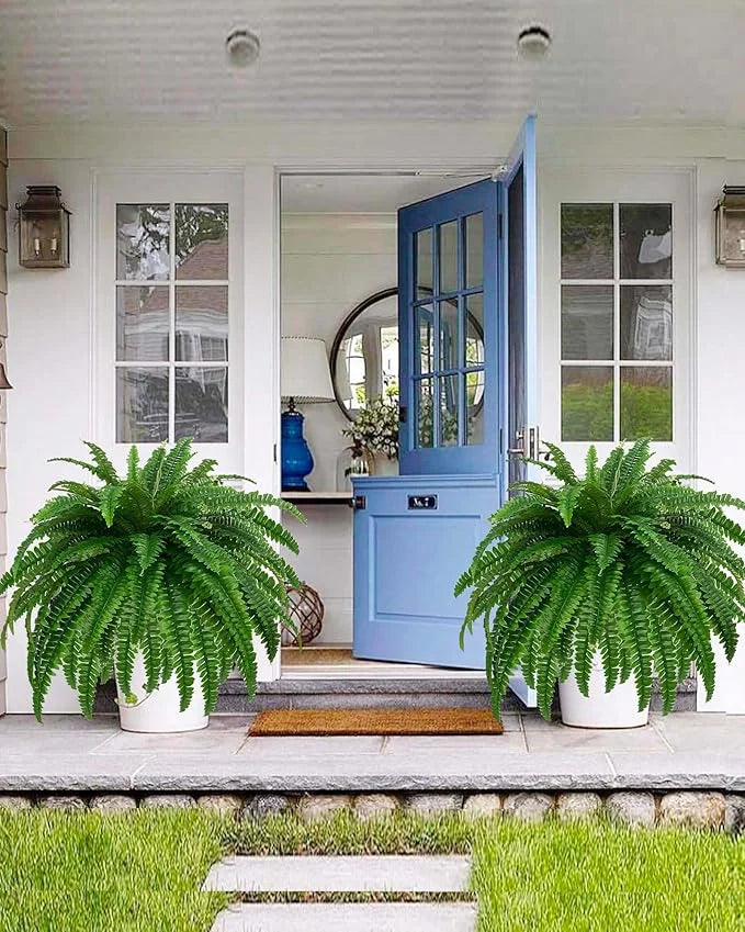 Nutshell artificial fern hanging plant styled in white pots as porch greenery flanking blue front door