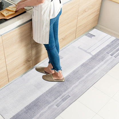 Nutshell grey hallway runner rug placed in a modern kitchen near a person preparing food