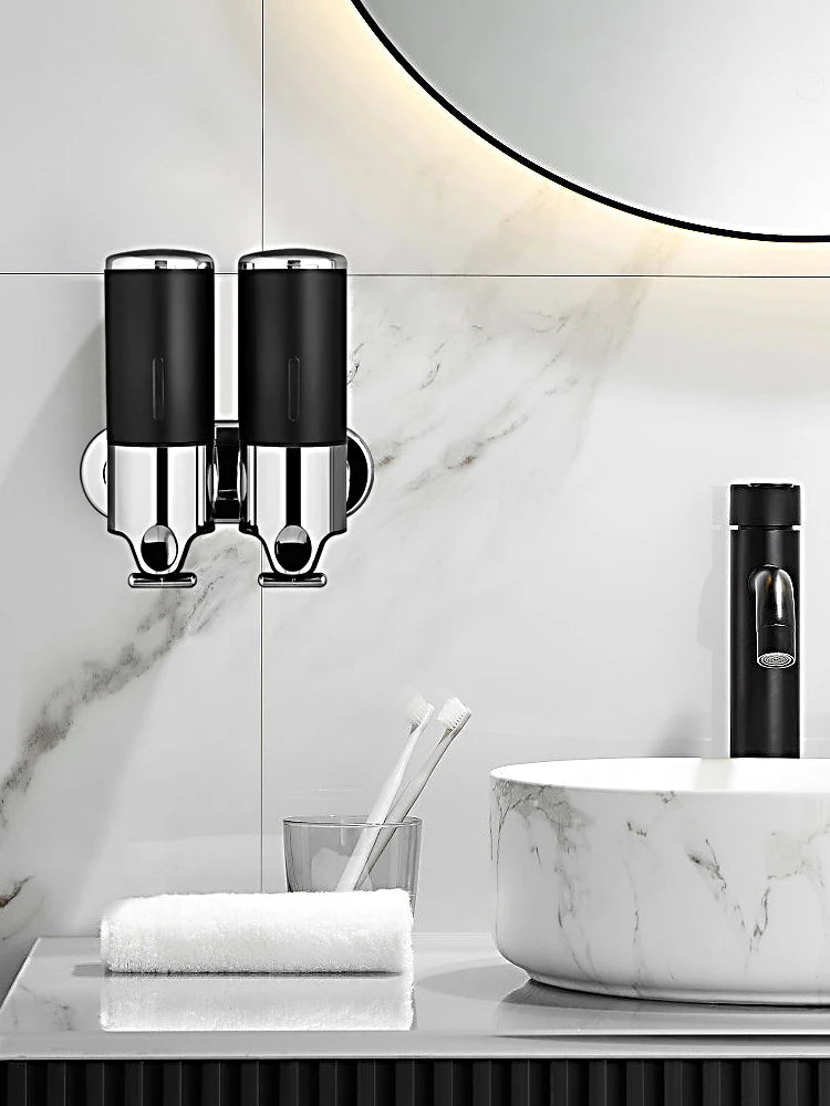 Nutshell Hand Liquid Soap Dispensers in black with chrome finish, mounted on bathroom wall above sink