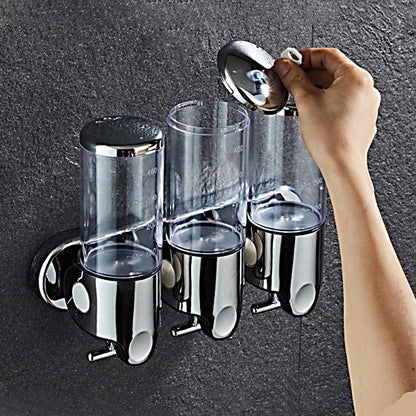 Nutshell Hand Liquid Soap Dispensers mounted on a wall with a hand opening the lid