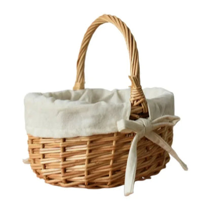Nutshell handcrafted wicker basket with fabric lining and a bow on the handle