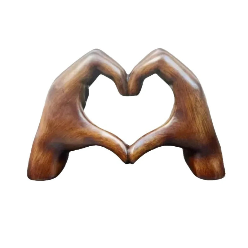 Brown heart-shaped resin sculpture decor featuring two hands creating a heart shape
