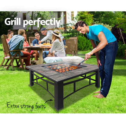 Nutshell Heavy Duty 2 in 1 Fire Pit and BBQ Grill in use while grilling outdoors with friends