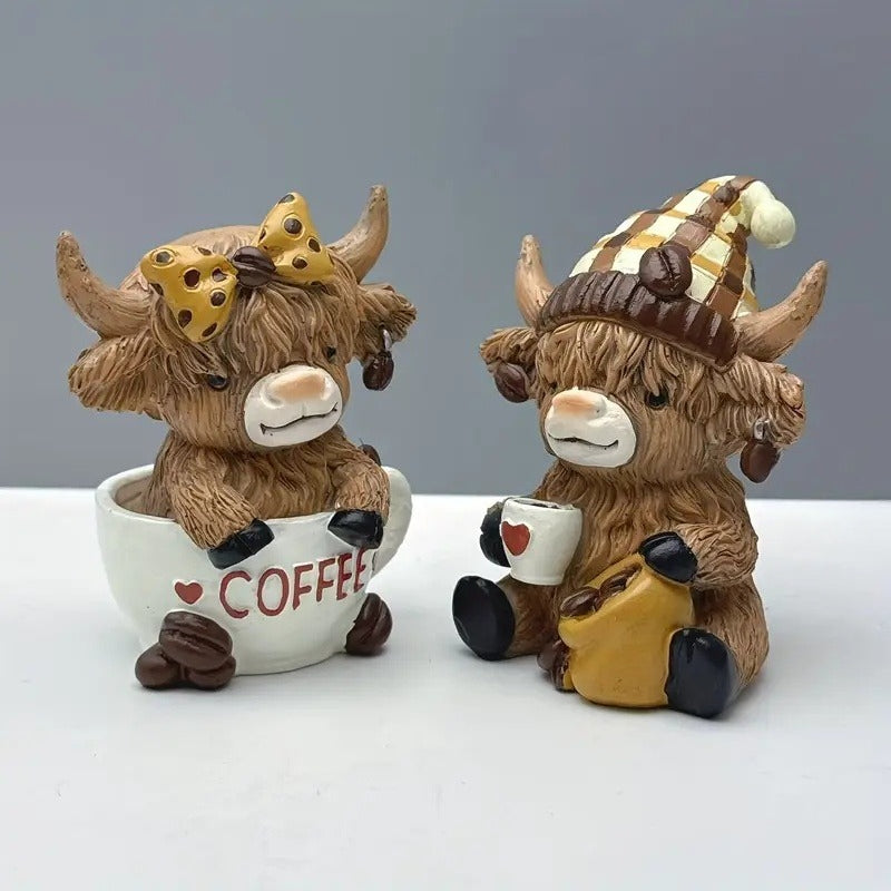 Highland cow coffee decor figurines featuring two cute cows with coffee mugs and accessories