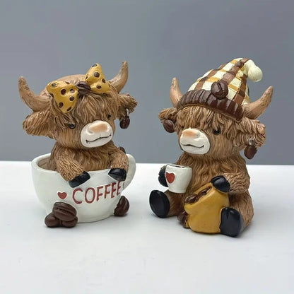 Highland cow coffee decor figurines featuring two cute cows with coffee mugs and accessories