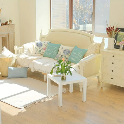 Cozy living room with a home decor cushion cover set on a cream vintage sofa near a white table and wooden floor