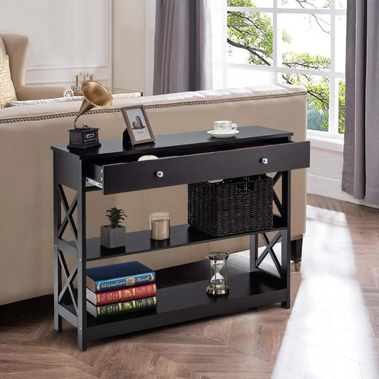 Nutshell 3-Tier Console Table in black with drawer two open shelves wicker basket lamp and books