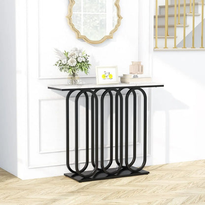Nutshell faux marble console table with white marble top and black geometric looped metal base in foyer