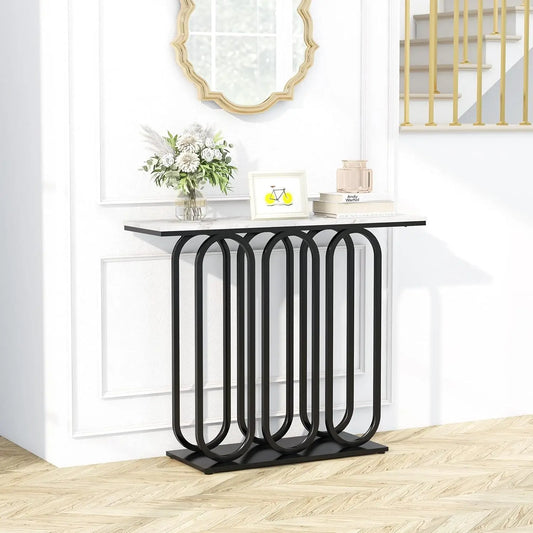 Nutshell faux marble console table with white marble top and black geometric looped metal base in foyer