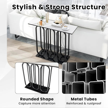 Nutshell faux marble console table with white top and black rounded metal tube base behind sofa