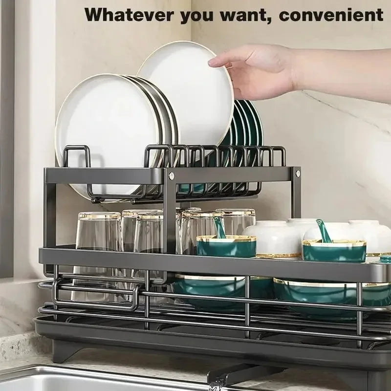 adjustable dish drying rack two tier black metal organizer holding plates glasses bowls with hand placing plate