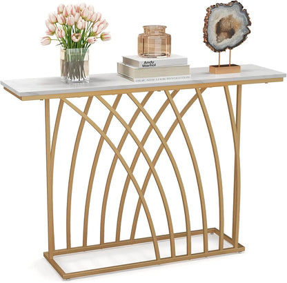 Nutshell modern gold console table with white marble top and arched gold metal base styled with tulips and geode decor