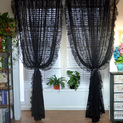 Nutshell black vintage voile ruffle lace drapes tied back over white blinds with potted plants