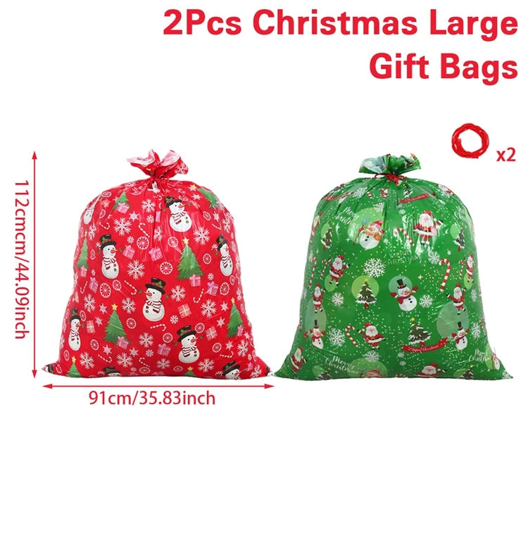 Two large Christmas gift bags in red and green with festive snowman and Santa designs, perfect for holiday gifting