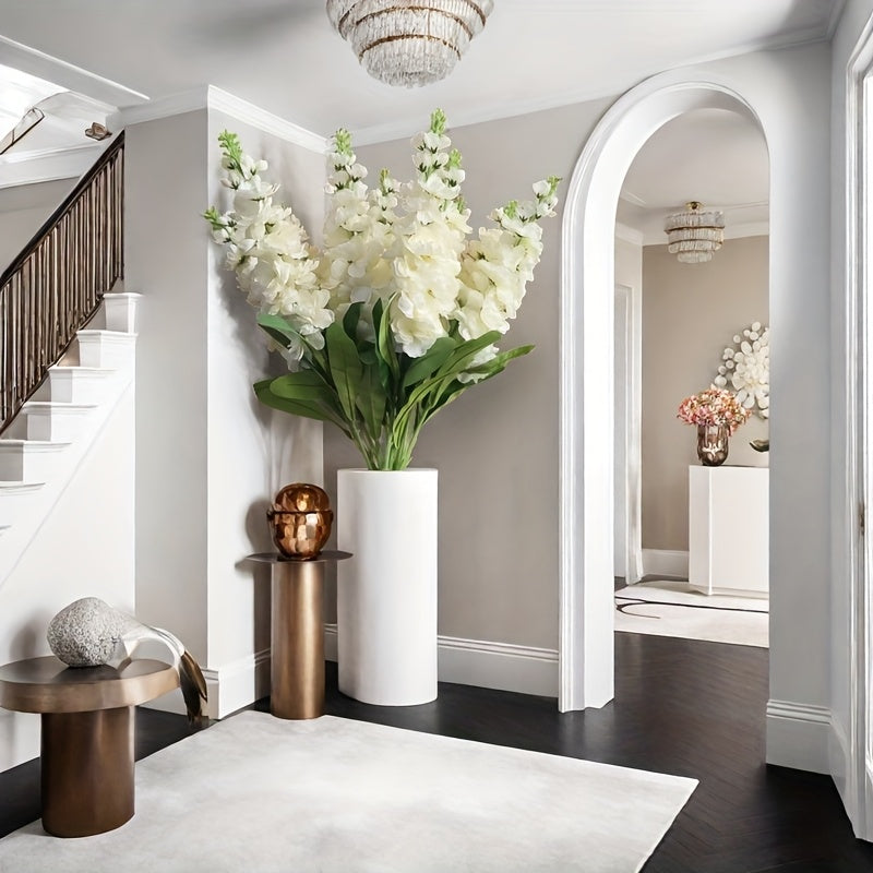 Large outdoor artificial delphinium in a chic white vase, enhancing modern interior decor