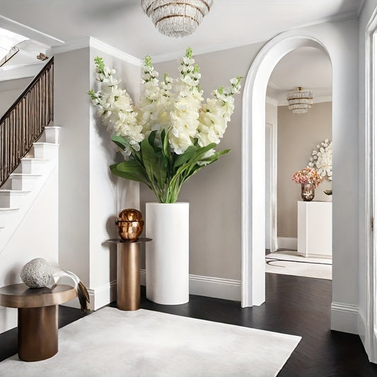 Large outdoor artificial delphinium in a chic white vase, enhancing modern interior decor
