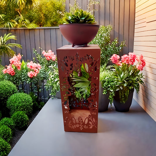 Large red iron flower pot with intricate cutout design, perfect for garden decoration
