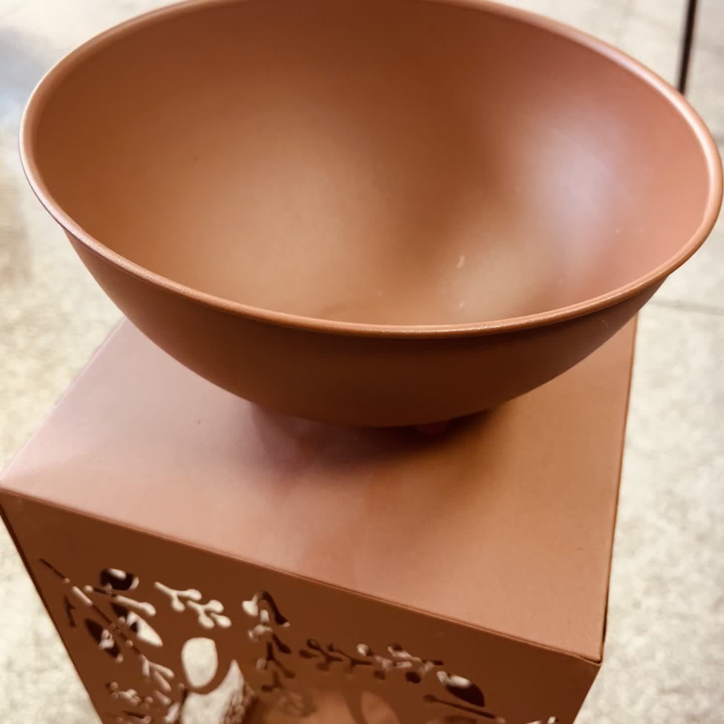 Large red iron flower pot designed for stylish plant displays and outdoor decor