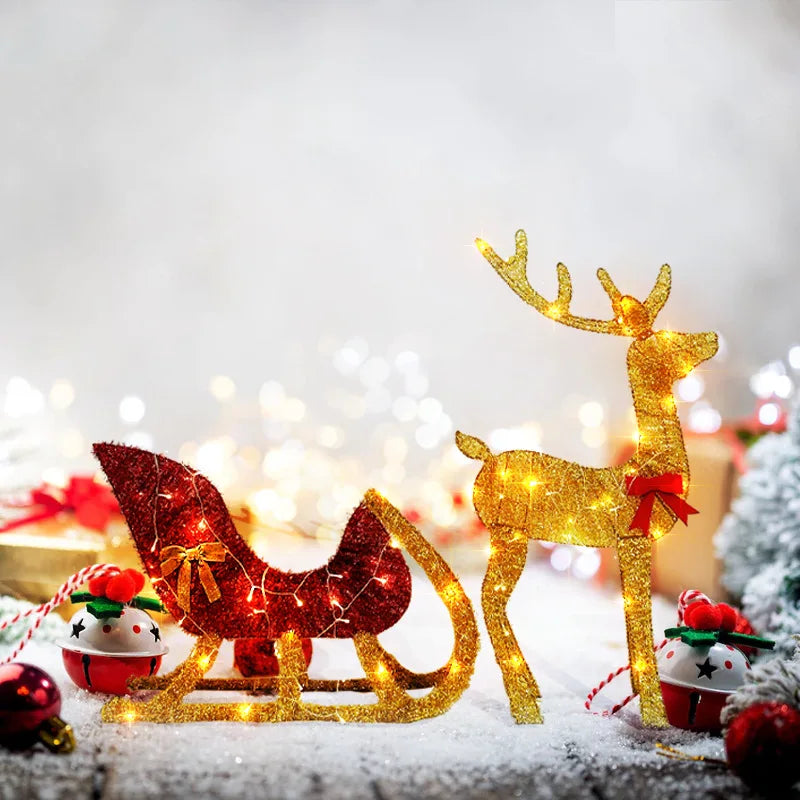 LED reindeer and sleigh outdoor Christmas decoration with sparkling lights on a snowy background