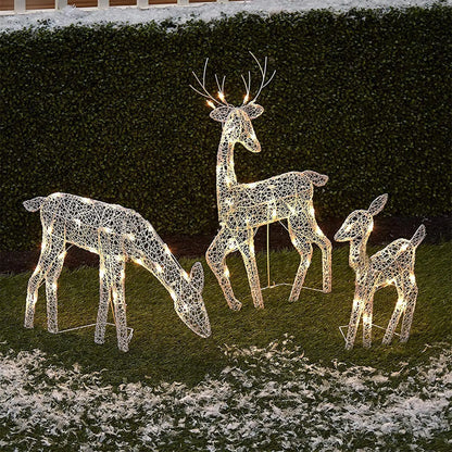 Lighted Christmas reindeer outdoor decoration set featuring three festive reindeer in a snowy yard