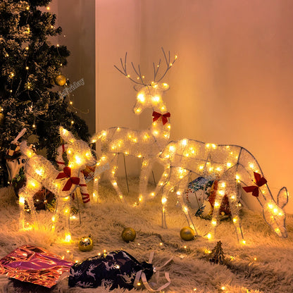 Lighted deer Christmas outdoor decoration with festive bows and glowing lights for holiday display