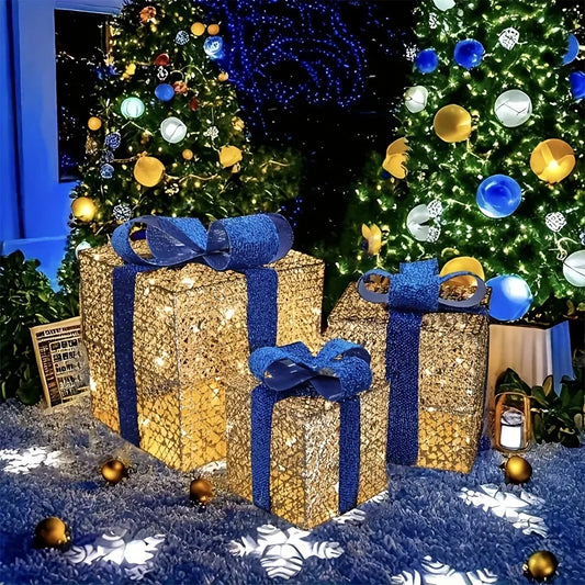 Luminous Christmas gift box decorations with blue bows beside festive trees and ornaments