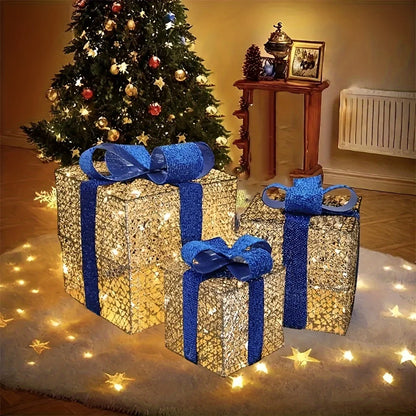 Luminous Christmas gift box decorations with blue bows, set against a festive tree backdrop