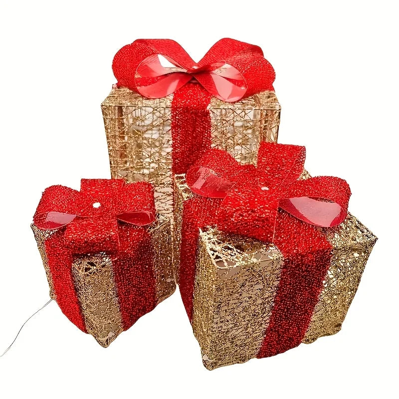 Set of three luminous Christmas gift box decorations in red and gold with festive bows