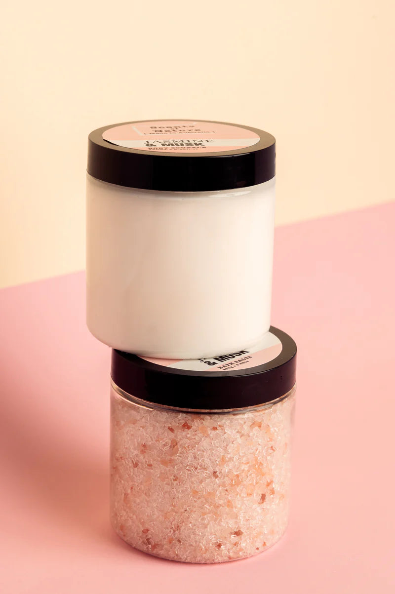 Nutshell luxurious bath salts set with pink Himalayan salt crystals and white bath soak in jars