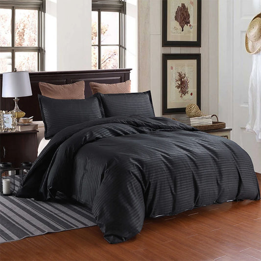 Nutshell black satin duvet cover set on a bed with matching pillow shams in a stylish bedroom