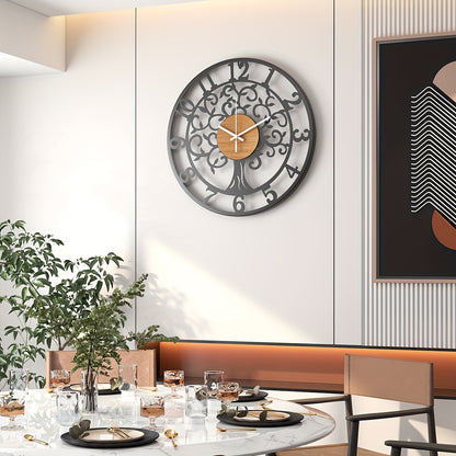 Stylish metallic black frame clock with a tree design, perfect for modern home decor.