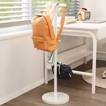 White Nutshell coat stand holding a tan backpack and jacket next to a desk School Bag Storage Rack