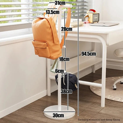 Nutshell white coat stand used as School Bag Storage Rack holding two backpacks beside desk