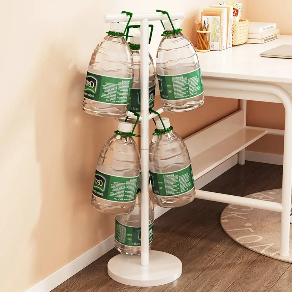 Nutshell white coat stand used as School Bag Storage Rack holding water jugs by hooks beside a study desk