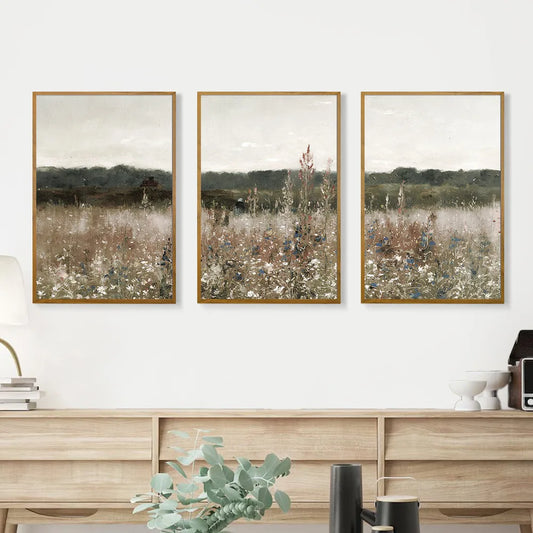 Three pieces of minimalist vintage landscape wall art featuring serene fields and muted colors