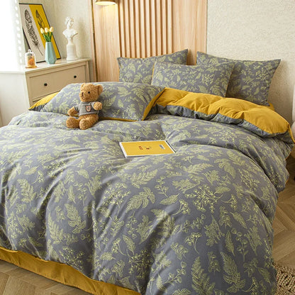 Nutshell modern floral quilt cover with green leaf pattern and mustard yellow accents on bed