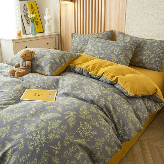Nutshell modern floral quilt cover with green leaf patterns on gray background and mustard yellow accents on bed