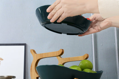 Nutshell fruit bowl on wooden Multi-Tier Serving Stand with green apples being placed inside