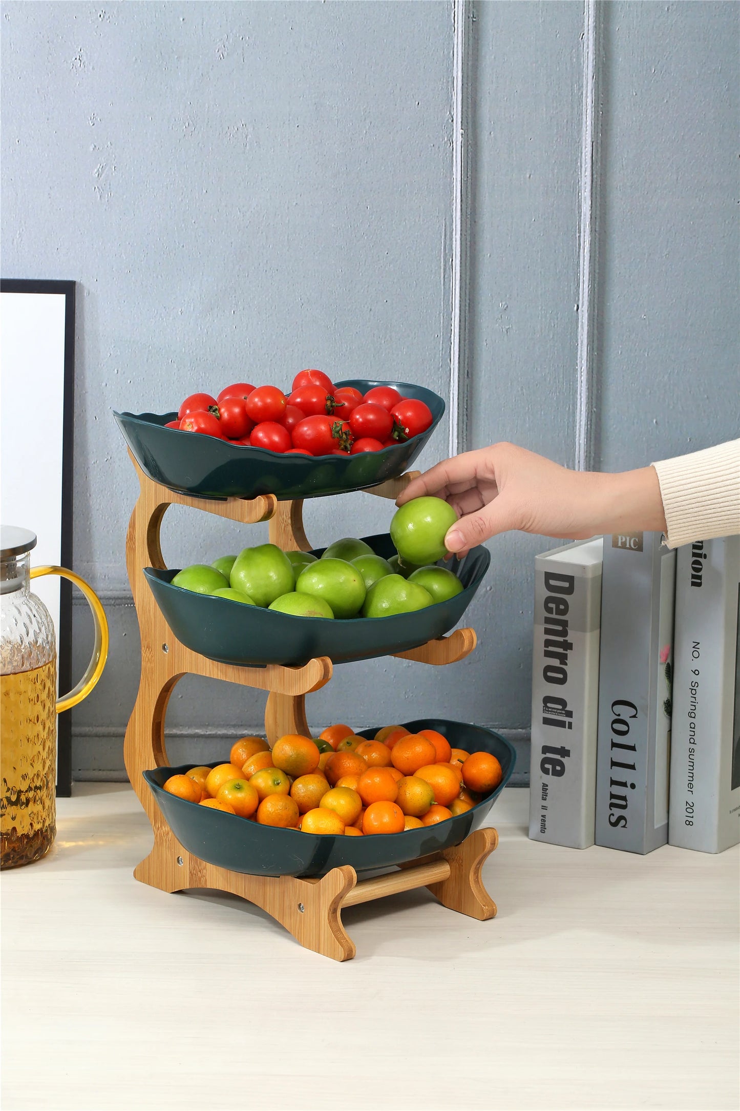 Nutshell multi-tier serving stand fruit bowl with three tiers holding tomatoes, green apples, and oranges